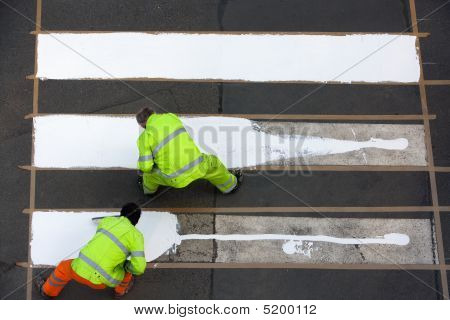 Picture or Photo of Workers painting crosswalk with white colour - view from above