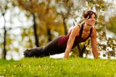 pic of fitness  - A caucasian female doing push ups in the park - JPG 