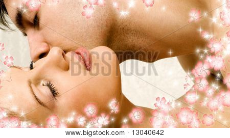 kissing couple in bed surrounded by rendered flowers