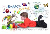 stock photo of animals  - A young boy child is looking at a laptop computer with math - JPG 