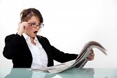 image of newspaper  - Businesswoman shocked at her newspaper - JPG 