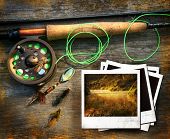 stock photo of dead-line  - Fly fishing rod with instant photo pictures on wood background - JPG 