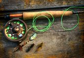 pic of dead-line  - Fly fishing rod with  on wood background - JPG 