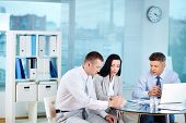 stock photo of meeting  - Image of confident partners sharing new ideas at meeting - JPG 