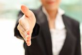 picture of business concept  - Business woman gives a handshake - JPG 
