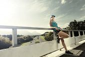 picture of bridge  - portrait of an athlete resting after running workout outdoors on a bridge - JPG 