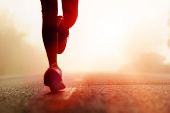 stock photo of health  - Runner athlete feet running on road - JPG 