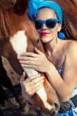 picture of horse  - Beautiful young woman wearing blue dress with a horse outdoor - JPG 