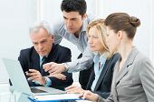 stock photo of people  - Team Of Business People Working Together On A Laptop - JPG 