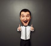foto of businessmen  - happy businessman with big head showing two thumbs up and laughing - JPG 