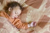 picture of toddlers  - Portrait of a cute baby or toddler child boy or girl sleeping on a pillow in a bed - JPG 