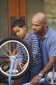 picture of fix  - Father helping son fix bike - JPG 