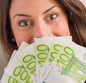 picture of currency  - Happy Woman Holding Euro Currency - JPG 