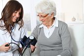 picture of pressure  - Closeup of nurse checking senior woman blood pressure - JPG 