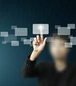 stock photo of future technology  - hand pushing on a touch screen interface - JPG 