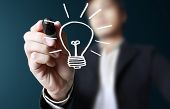 picture of light  - hand with a pen drawing light bulb - JPG 