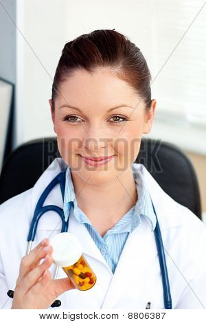 Close-up Of A Smiling Female Doctor Holding Pills In Her Office