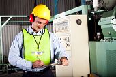 foto of industrial  - male occupational health and safety officer inside factory doing inspection - JPG 