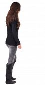 stock photo of people  - back view of walking  woman  in  in jeans and sweater - JPG 