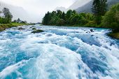 image of rush  - Milky blue glacial water of Briksdal River in Norway - JPG 