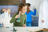 picture of science  - Elementary age school girl looking at test tube in science class at primary school - JPG 