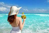 image of beach  - beach hat profile girl drinking a coconut fresh cocktail in tropical Caribbean sea - JPG 