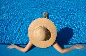 stock photo of rest  - Woman in hat relaxing at the pool - JPG 
