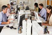 picture of team  - Team Working At Desks In Busy Office - JPG 