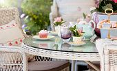 picture of opulence  - Afternoon tea and cakes in the garden with wicker furniture - JPG 