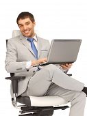 stock photo of business people  - picture of young businessman sitting in chair with laptop - JPG 