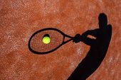 pic of competition  - shadow of a tennis player in action on a tennis court  - JPG 