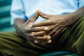 pic of africans  - closeup of hands of elderly african american man sitting on bench - JPG 