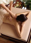 picture of pressure  - Woman in a day spa getting a deep tissue massage therapy - JPG 