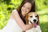 foto of outdoor  - Portrait of a woman with her beautiful dog outdoors - JPG 