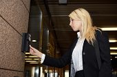 picture of entrance  - Young businesswoman entering access code at building entrance - JPG 