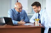 pic of meeting  - senior and junior businessman discuss something during their meeting - JPG 