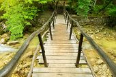 picture of bridge  - The wooden bridge through fast mountain small river - JPG 