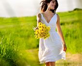 picture of nature  - Candid skipping carefree adorable woman in field with flowers at summer sunset - JPG 