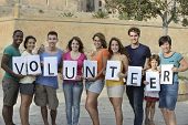 picture of group  - happy and diverse volunteer group holding sign - JPG 