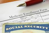 stock photo of security  - Social Security card and Medicare enrollment form - JPG 