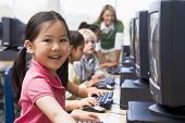 image of computer  - Children at computer terminals with teacher in background  - JPG 