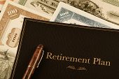 image of shareholders  - retirement plan portfolio on top of vintage stock certificates - JPG 