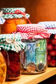 picture of money  - Money conserved in a glass jar .
Shallow deep of focus. - JPG 