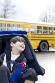 stock photo of cerebral  - Disabled five year old boy in wheelchair by schoolbus - JPG 