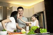 stock photo of tilting  - Asian Family spending time together in the kitchen - JPG 