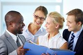 picture of meeting  - Portrait of confident employees looking at document at meeting - JPG 
