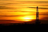 image of sunset  - Oil derrick and hot sunset are signs or search for black gold - JPG 