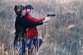 pic of security  - Mother teaching her young daughter how to safely and correctly use a handgun - JPG 