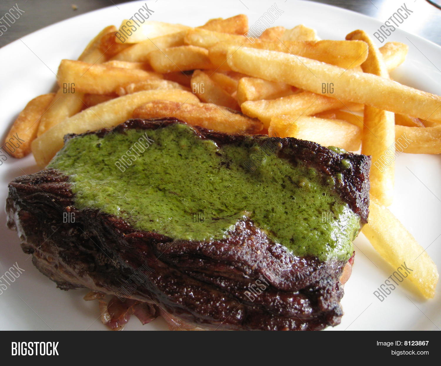 Steak and fries with green garlic sauce Stock Photo & Stock Images