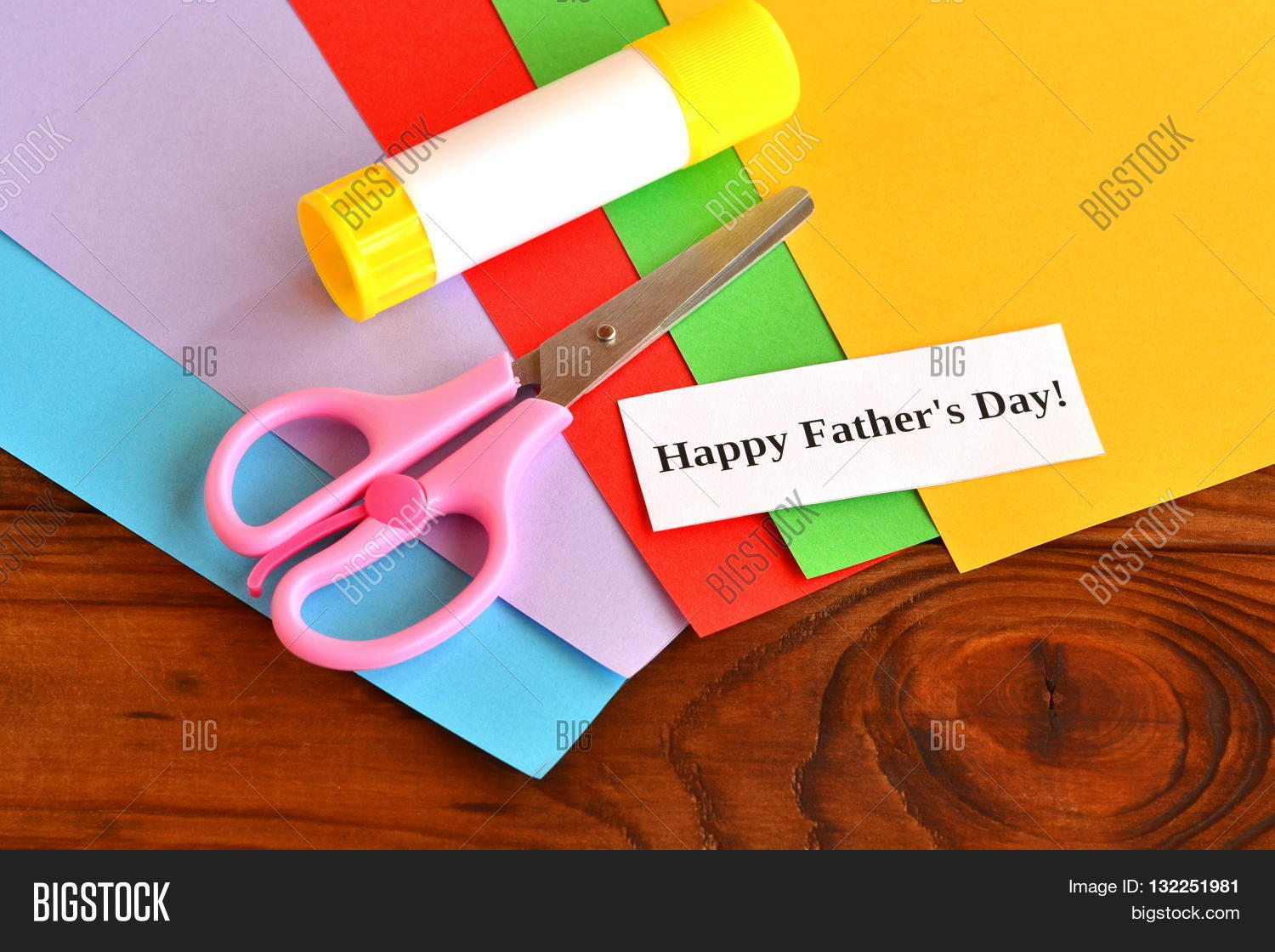 Sheets of colored paper, glue stick, scissors, a piece of white paper